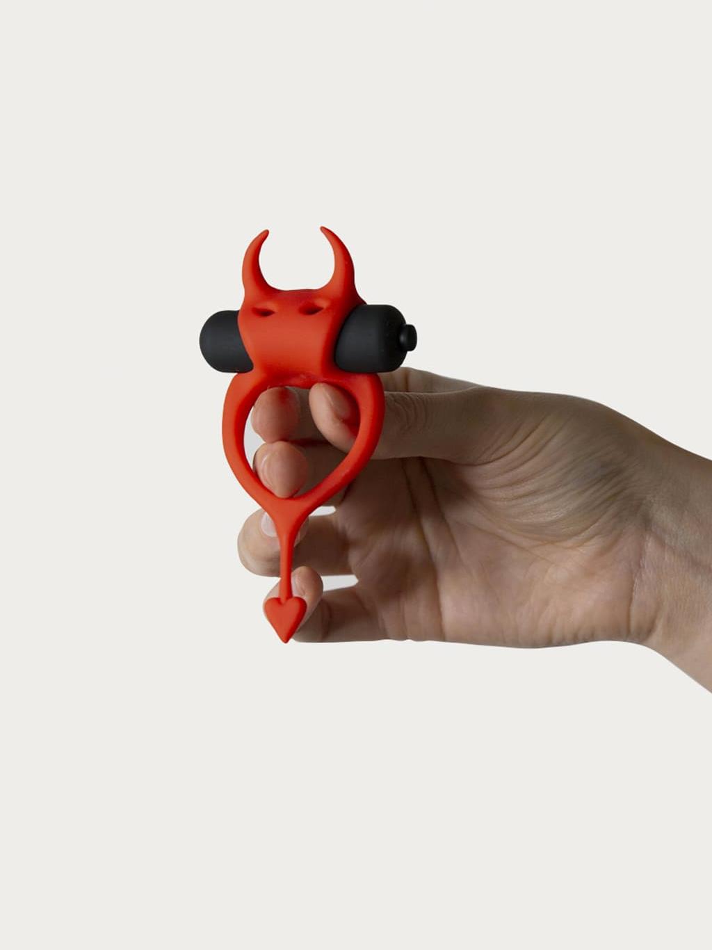 Someone holding the penis ring in the middle.